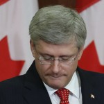 Canada's PM Harper pauses while delivering a speech during a Conservative caucus meeting on Parliament Hill in Ottawa